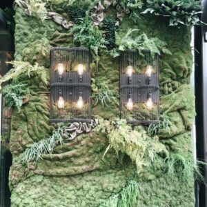 a live moss wall and caged exposed bulb sconces at Townhouse Detroit